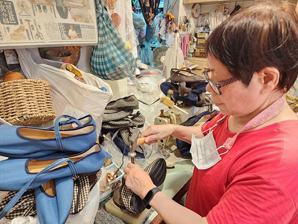 「年繡花鞋」製鞋師傅陳太太為繡花鞋釘上扣環。（鄭佩雯拍攝）  圖片來源：記者  林 清 雲